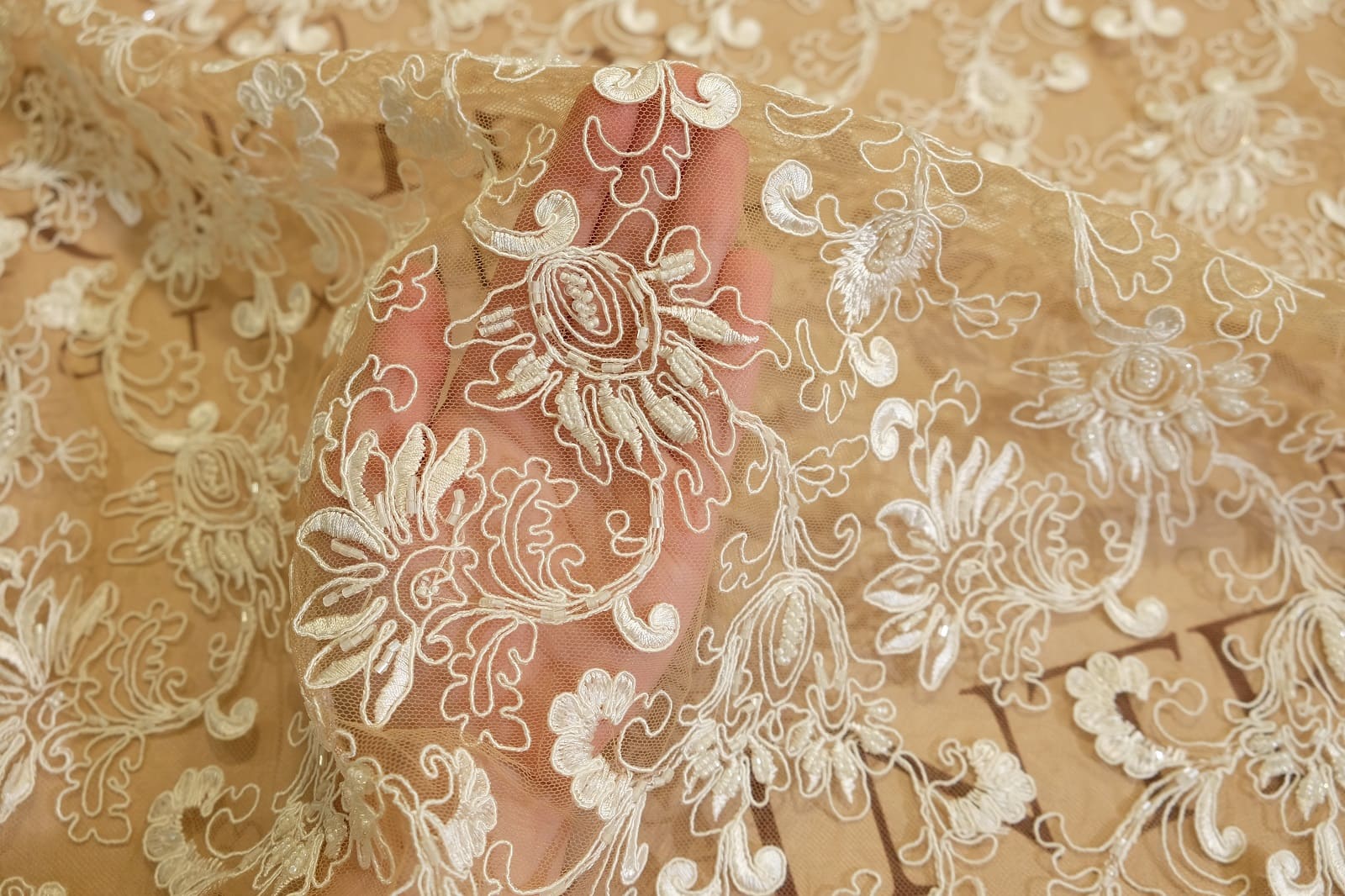 lace fabric with cord and embroidery on hand 310848